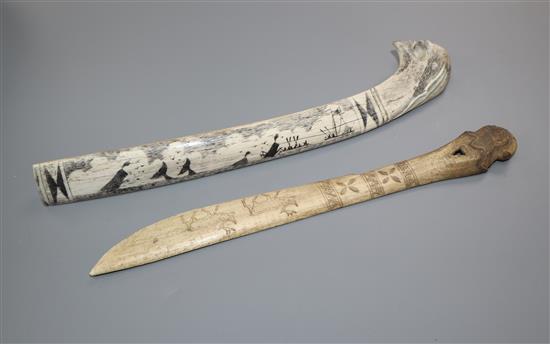 An eskimo scrimshaw elk bone and a similar paper knife,